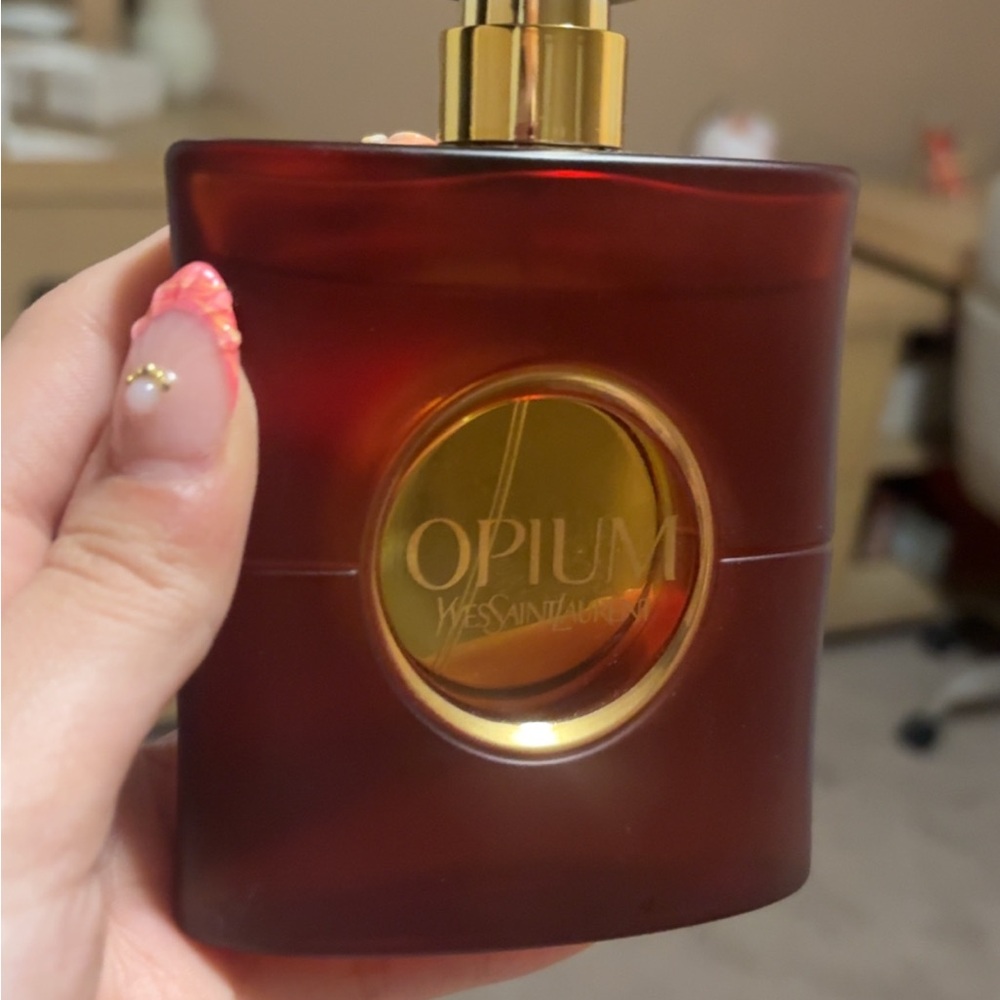 Yves Saint Laurent Opium Eau de Parfume over red - Deep Red and Gold